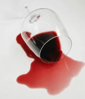Una copa con vino en el piso